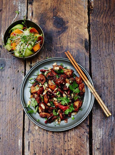 plate of kung pao chicken with a side salad